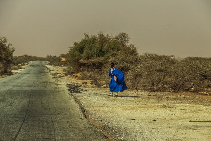 Man standing next to the road in Mauritania
