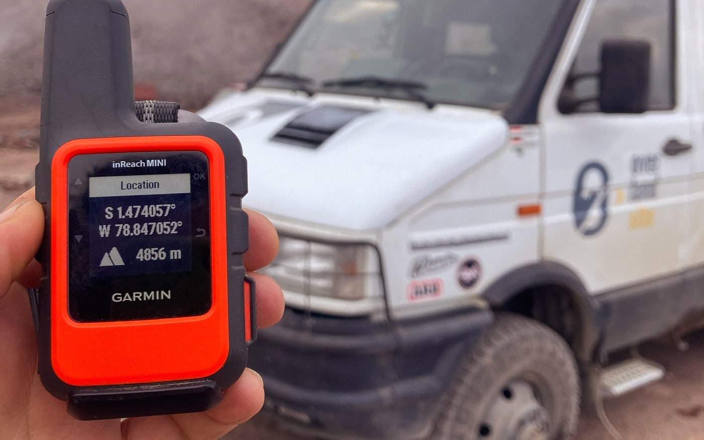 A Garmin inReach Mini showing an altitude of 4,856 metres, the van behind